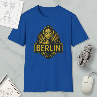 a blue t-shirt with a graphic design of a robot or character, along with a computer mouse and other office supplies.
