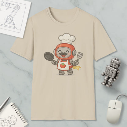 a t-shirt with a cartoon robot chef, a spoon, a spatula, a notebook, a pen, a mouse, and a robot on a marble surface.