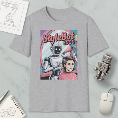 a gray t-shirt with a graphic design depicting a robot hairdresser styling a woman's hair. The t-shirt is surrounded by various objects, including a computer mouse, a notebook, and a toy robot.