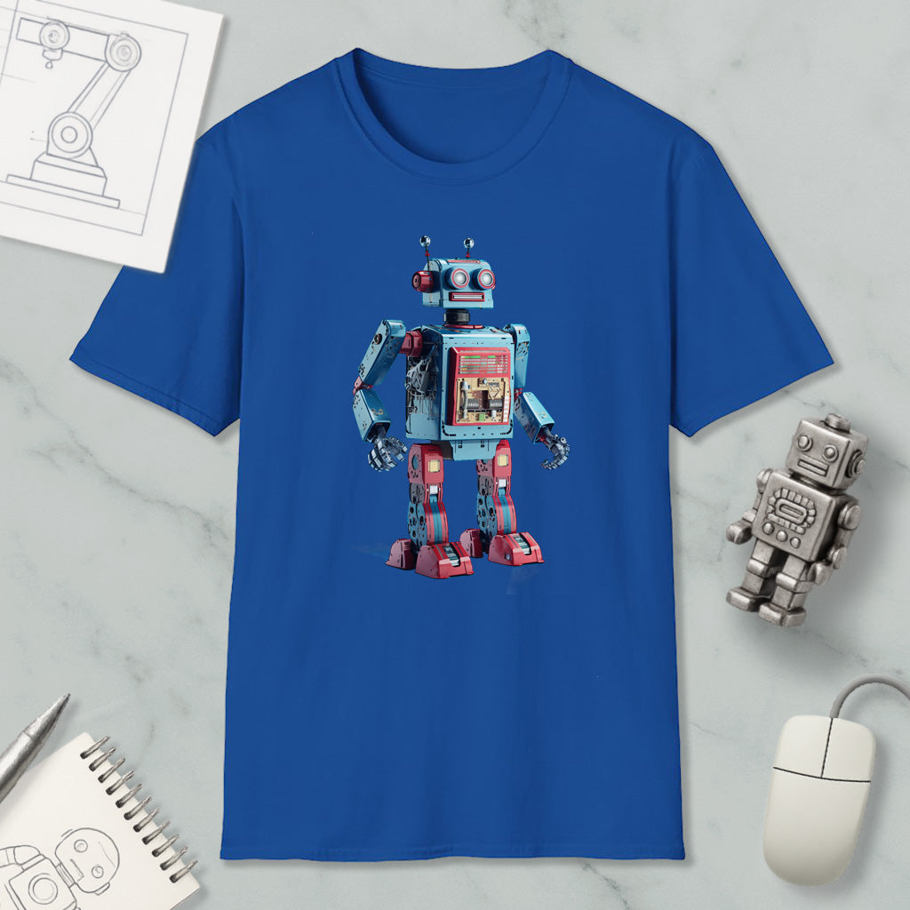 a blue t-shirt with a robot design, along with a computer mouse, a notebook, and a pen on a marble surface.