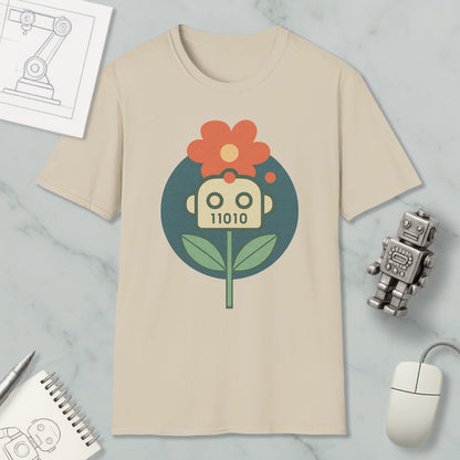 a beige t-shirt with a graphic design of a flower and a robot, along with various office supplies such as a notebook, a mouse, and a pen.