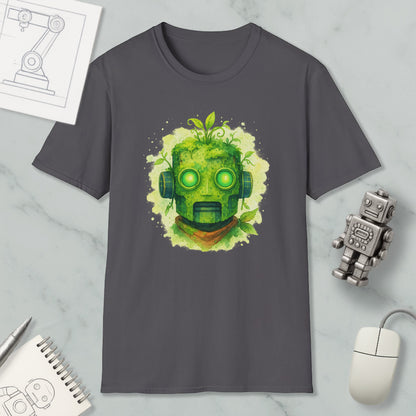 a gray t-shirt with a green robot-like face design, surrounded by various objects such as a computer mouse, a notebook, and a small robot figurine.