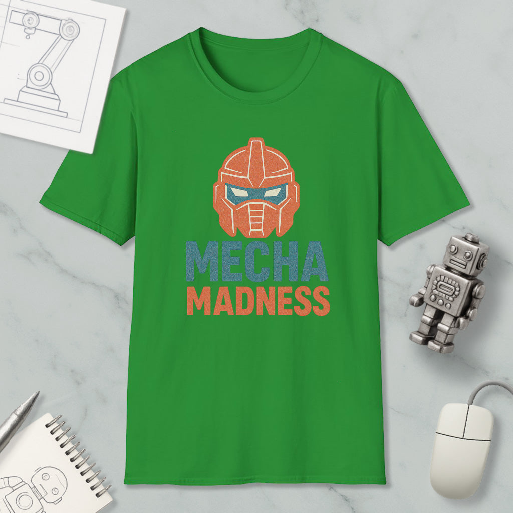 a green t-shirt with a graphic design of a robot or robot-like character, along with the text "MECHA MADNESS" printed on it. The t-shirt is displayed on a marble surface, and there are various objects such as a computer mouse, a notebook, and a small robot figurine placed around it.