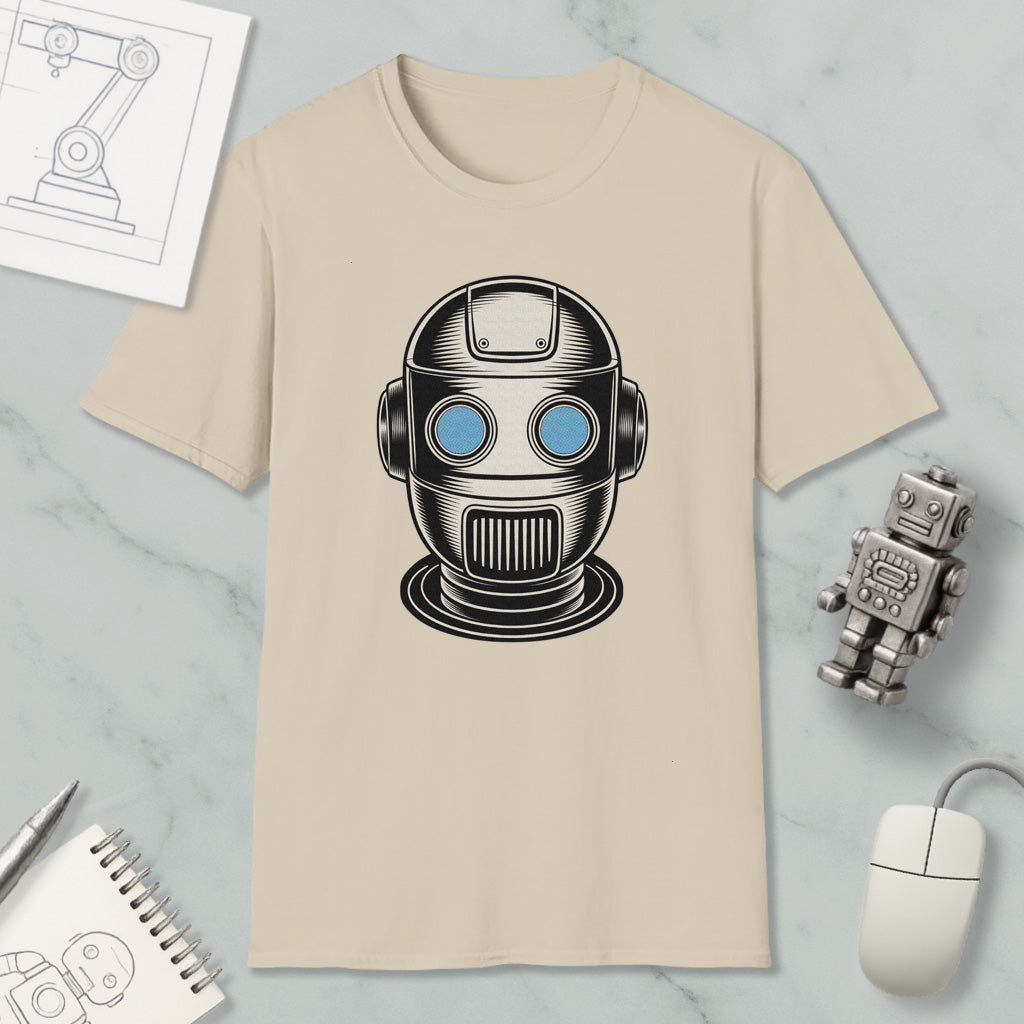 a beige t-shirt with a graphic of a robot or robot head, along with various objects such as a computer mouse, a notebook, and a pen.