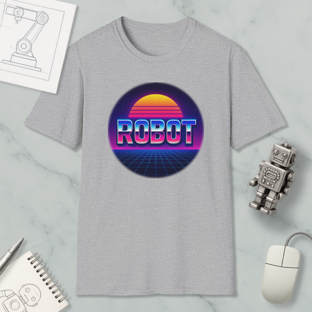 a gray t-shirt with a graphic design of a robot and a sunset, along with various office supplies such as a mouse, a notebook, and a pen.
