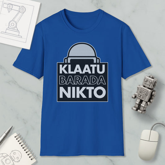 a blue t-shirt with a graphic design, a computer mouse, a notebook, and a small robot figurine.