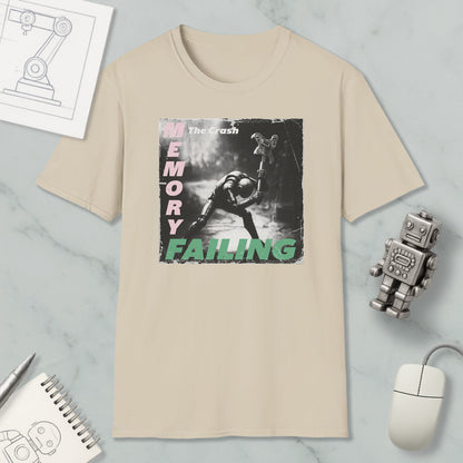 a beige t-shirt with a graphic design depicting a person in a dark environment, along with the text "The Crash" and "Memory Failure". The t-shirt is displayed on a marble surface, accompanied by a computer mouse, a robot, and a notebook.