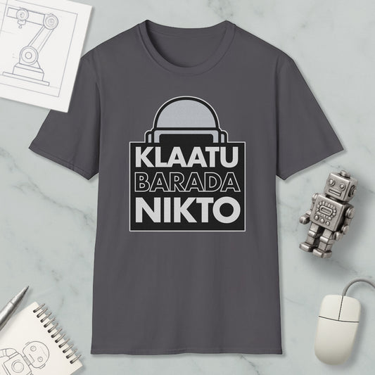 a gray t-shirt with a graphic design, a computer mouse, a notebook, and a small robot on a marble surface.