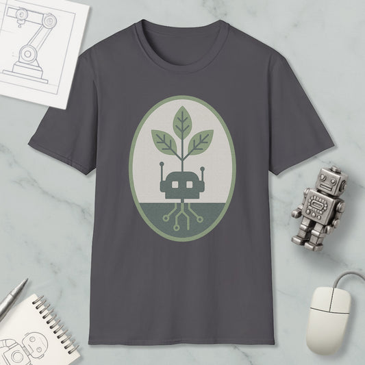 a gray t-shirt with a green and white graphic design, including a robot and a plant, along with various objects such as a mouse, a notebook, and a sketch.