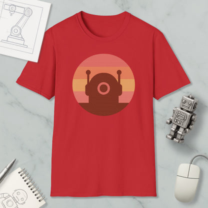 a red t-shirt with a graphic design of a robot or robot-like figure, along with a computer mouse, a notebook, and a pen on a marble surface.
