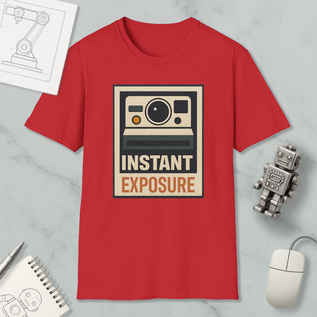 a red t-shirt with a graphic design of a camera and the text "INSTANT EXPOSURE" printed on it, along with a small robot and a computer mouse.