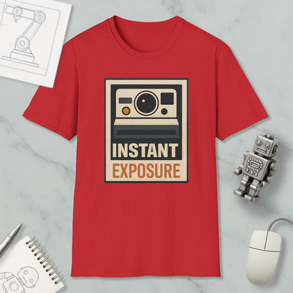 a red t-shirt with a graphic design of a camera and the text "INSTANT EXPOSURE" printed on it, along with a small robot and a computer mouse.