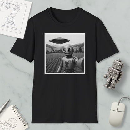 a black and white photograph of a robot with a large spaceship hovering above it, set against a field. Surrounding the photograph are various objects, including a notebook, a mouse, and a small robot figurine.